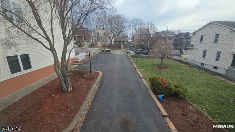 342 Sherman Street Passaic, NJ 07055 - Photo 3 of 32 a view of a backyard with large trees