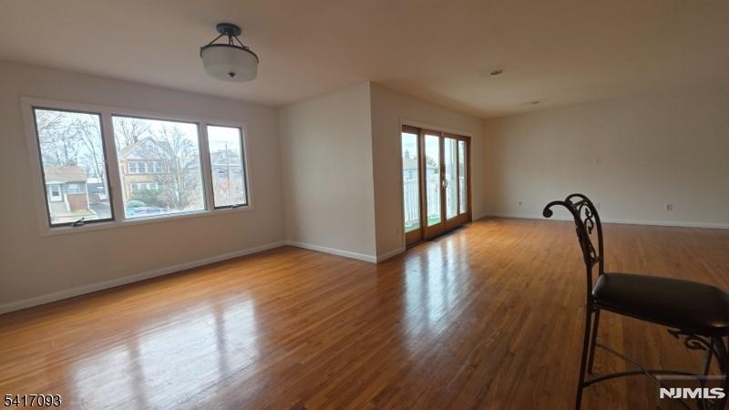 342 Sherman Street Passaic, NJ 07055 - Photo 7 of 32 a view of a room with windows and wooden floor