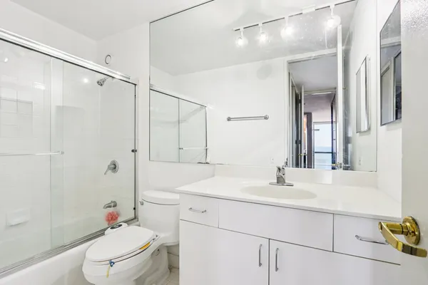 a bathroom with a sink toilet and shower