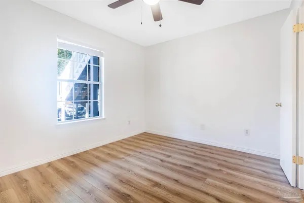 wooden floor in an empty room with a window