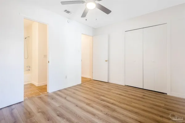 a view of a room with wooden floor