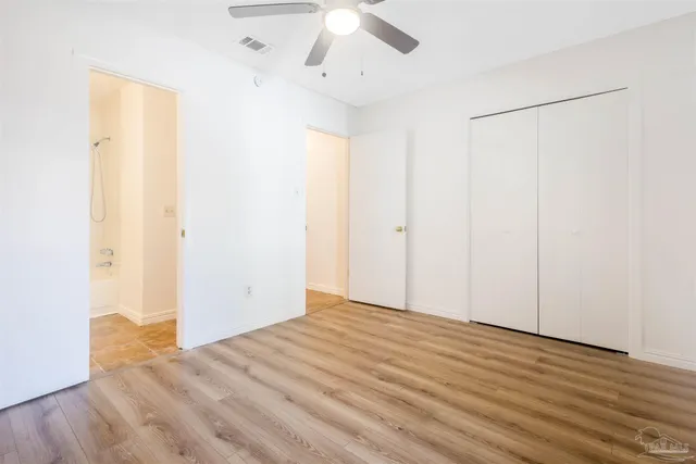 a view of a room with wooden floor