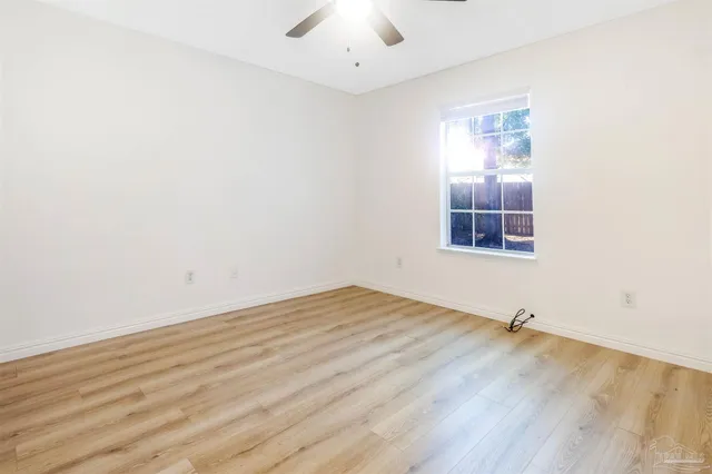 a view of a room with wooden floor and windows