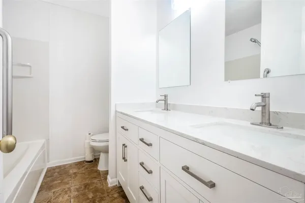 a bathroom with a bathtub and toilet