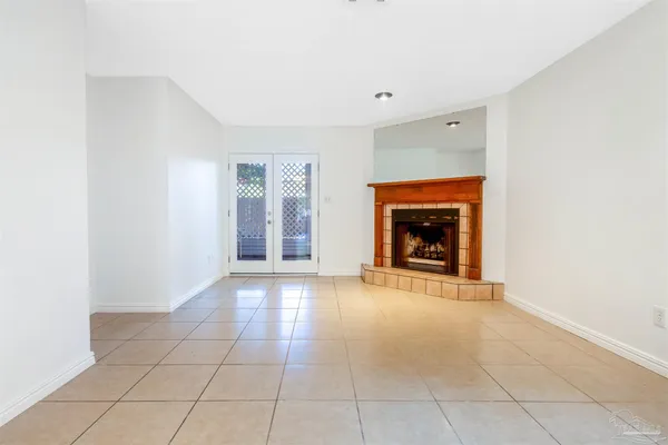 a view of an empty room with a fireplace