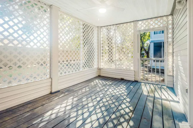 a view of a porch with wooden floor and windows