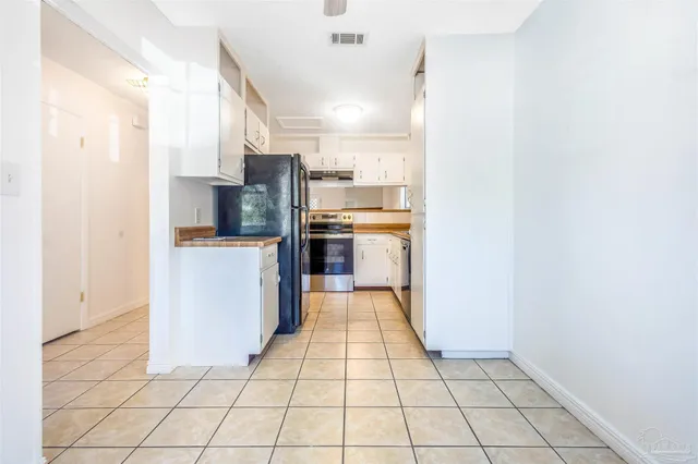 a kitchen with stainless steel appliances a refrigerator and a stove