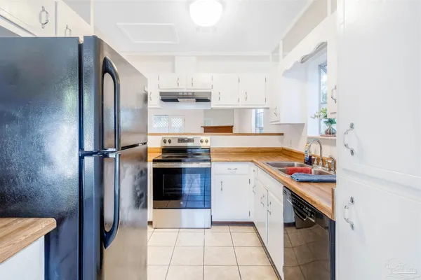 a kitchen with stainless steel appliances a sink stove and refrigerator