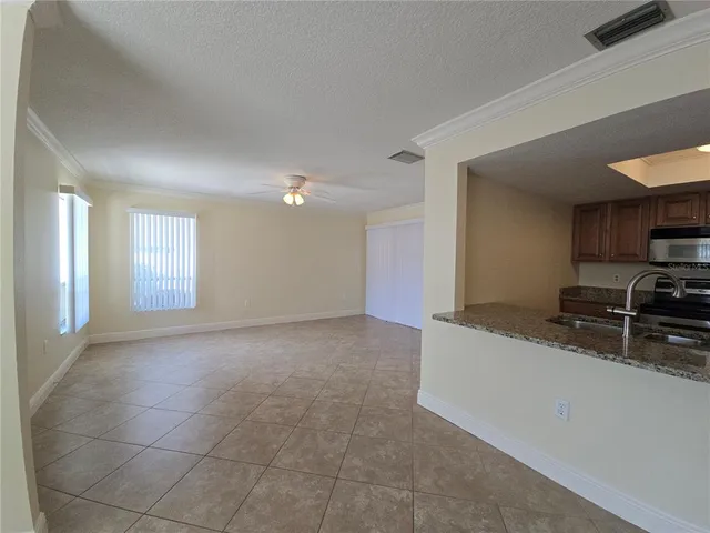 a view of a kitchen with a sink and dishwasher a stove top oven with wooden floor