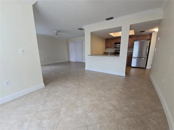 a view of a hallway to kitchen and a sink