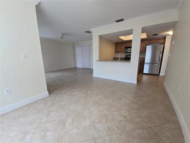 a view of a hallway to kitchen and a sink