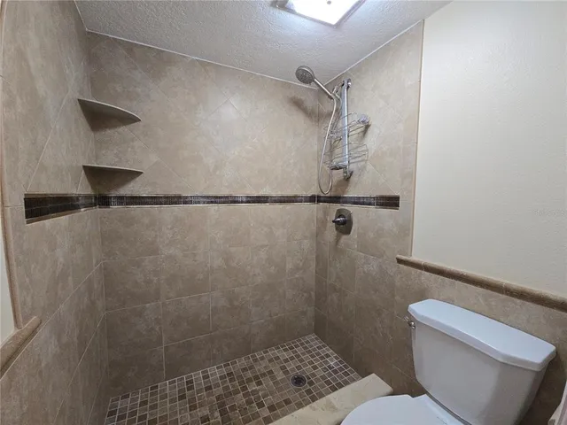 a bathroom with a shower and a toilet