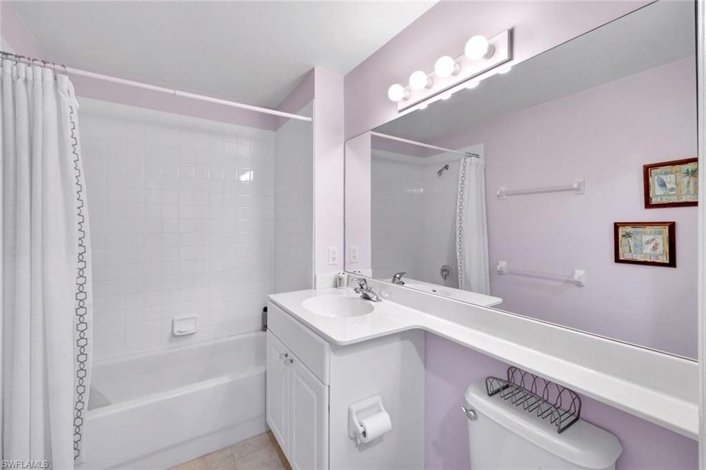 2190 Arielle Drive, Unit 903 Naples, FL 34109 - Photo 15 of 26 a bathroom with a sink a mirror and a bathtub