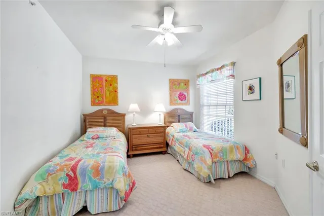 a bedroom with two beds and a chandelier