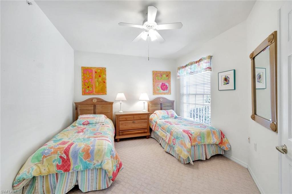 2190 Arielle Drive, Unit 903 Naples, FL 34109 - Photo 16 of 26 a bedroom with two beds and a chandelier