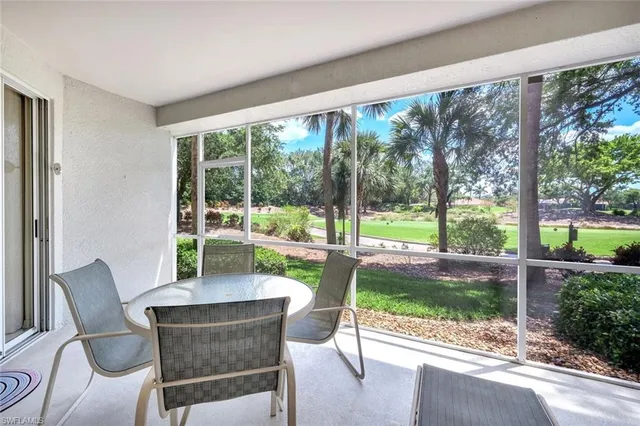 a dining room with wooden floor and a table and chairs