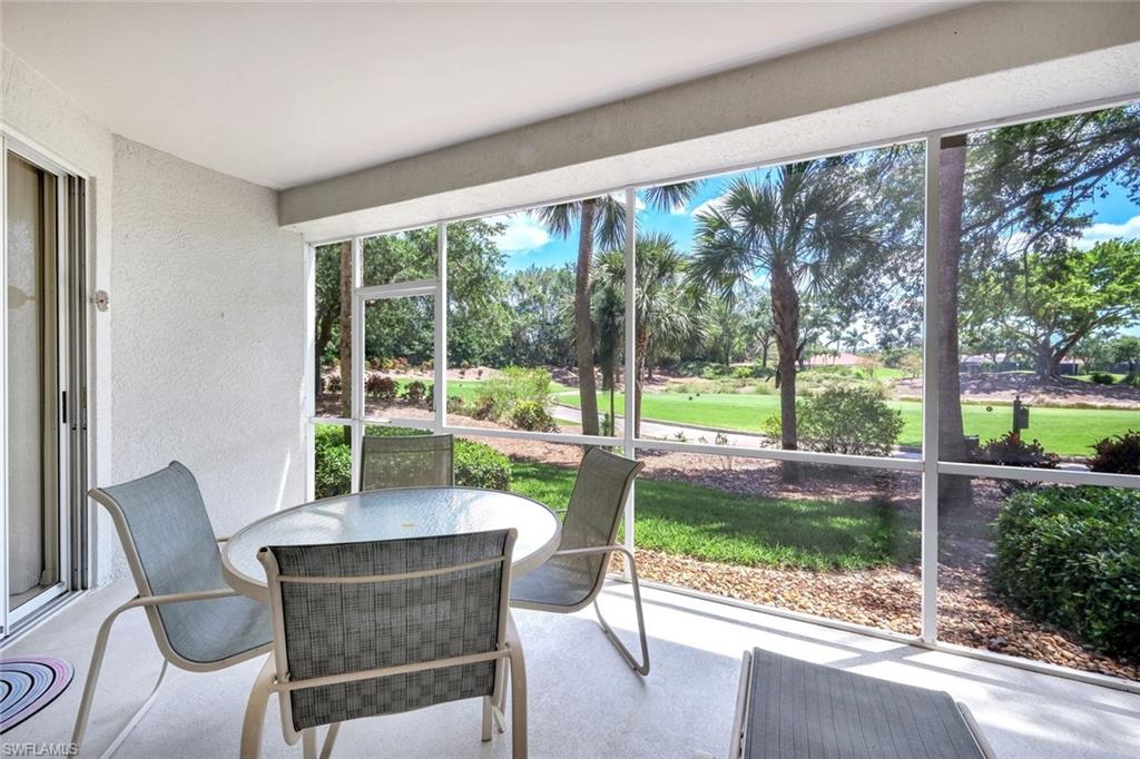 2190 Arielle Drive, Unit 903 Naples, FL 34109 - Photo 18 of 26 a dining room with wooden floor and a table and chairs