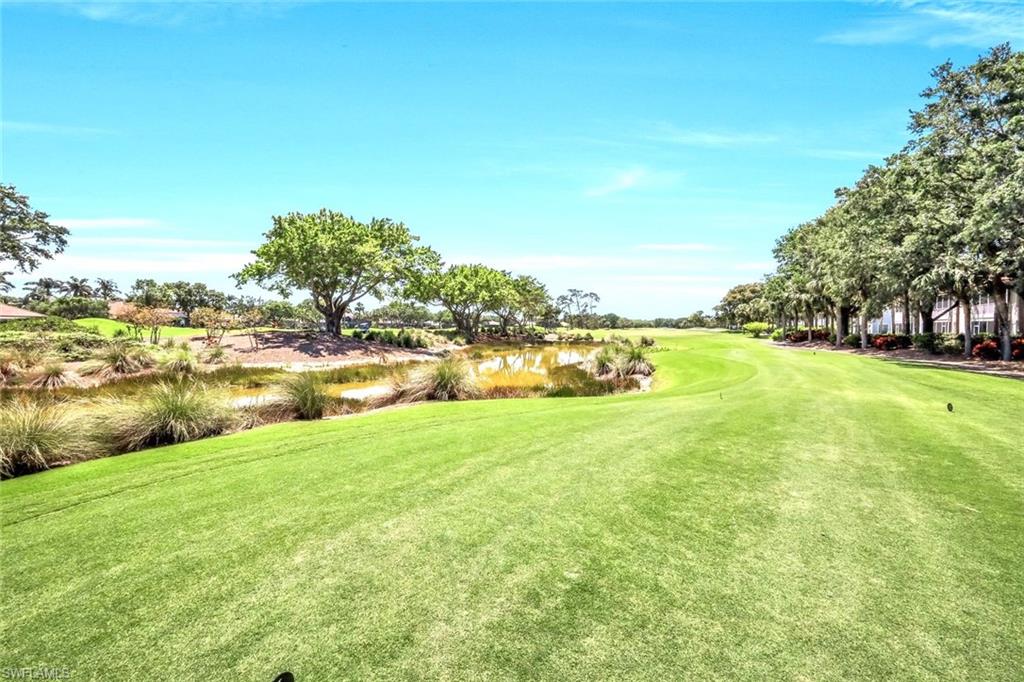 2190 Arielle Drive, Unit 903 Naples, FL 34109 - Photo 20 of 26 a view of a lake with houses in the background