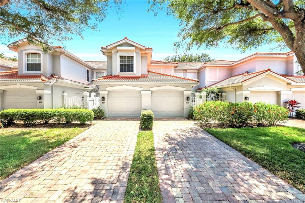 2190 Arielle Drive, Unit 903 Naples, FL 34109 - Photo 2 of 26 a front view of a house with a yard and garage
