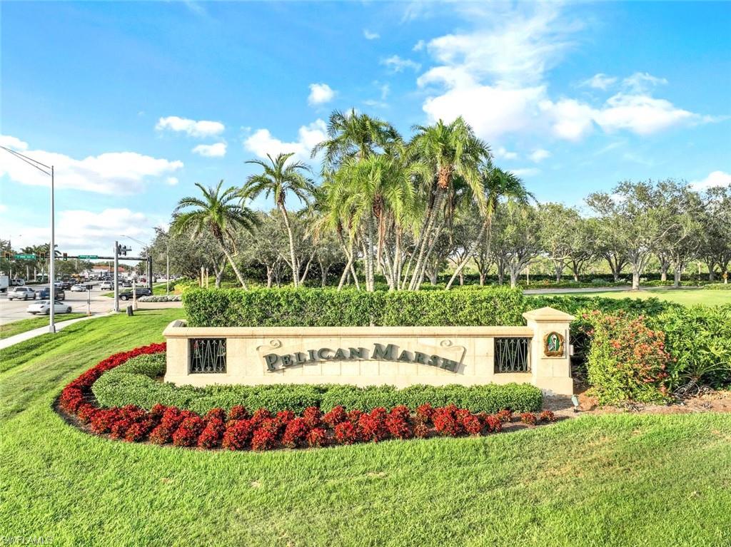 2190 Arielle Drive, Unit 903 Naples, FL 34109 - Photo 23 of 26 a view of a garden with a bench in the background