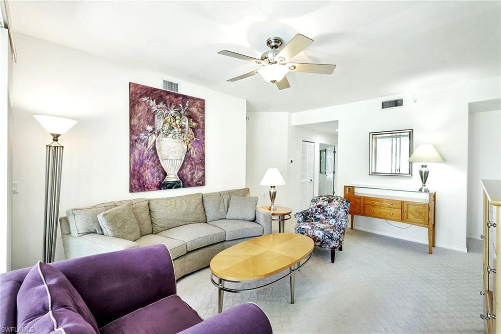 2190 Arielle Drive, Unit 903 Naples, FL 34109 - Photo 4 of 26 a living room with furniture and a chandelier