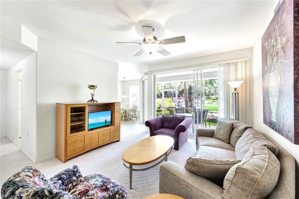 2190 Arielle Drive, Unit 903 Naples, FL 34109 - Photo 6 of 26 a living room with furniture and a large window