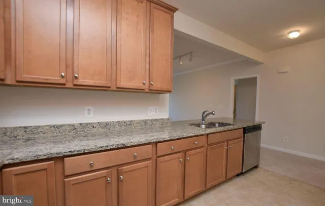 a bathroom with a refrigerator and a sink
