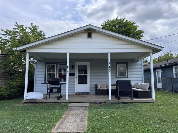 a view of a house with a yard porch and sitting area