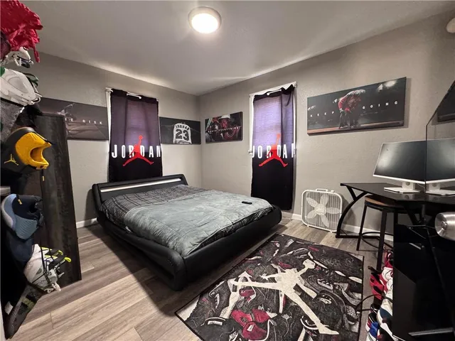 a bed room with a bed and a television