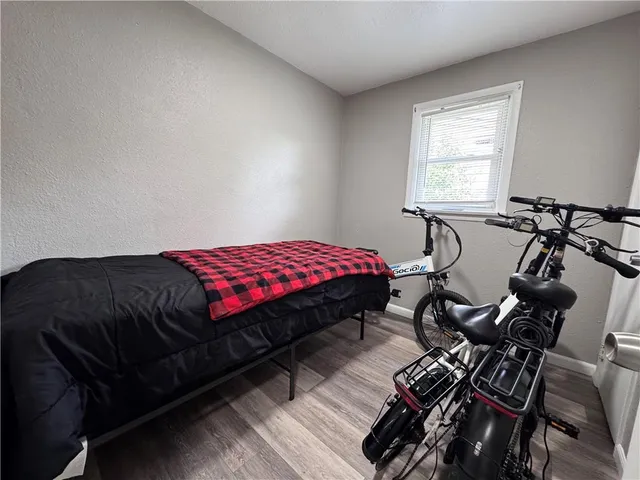 a bedroom with a bed dresser and a window