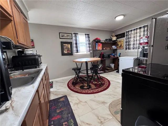 a view of a kitchen with a sink and wooden floor