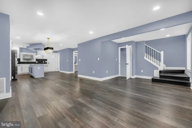 a view of kitchen with sink and wooden floor