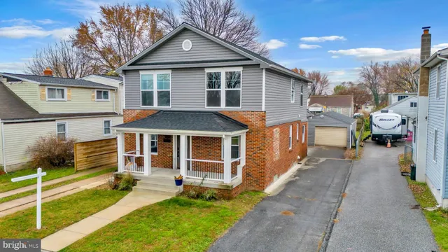 a view of a house with a yard and furniture