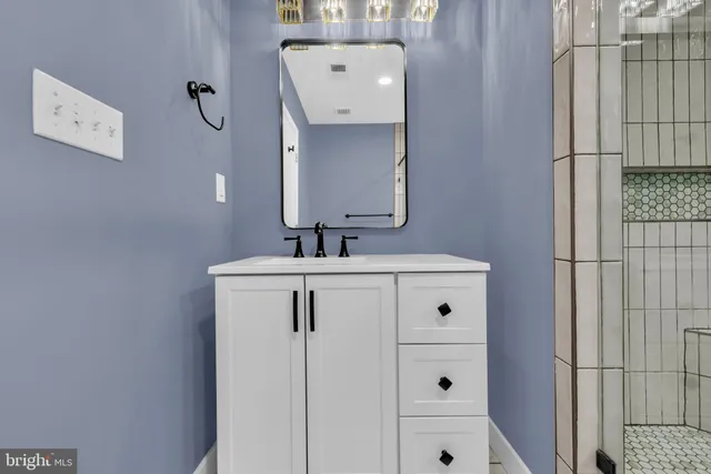 a bathroom with a sink and mirror