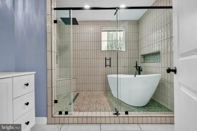 a bathroom with a bathtub and shower
