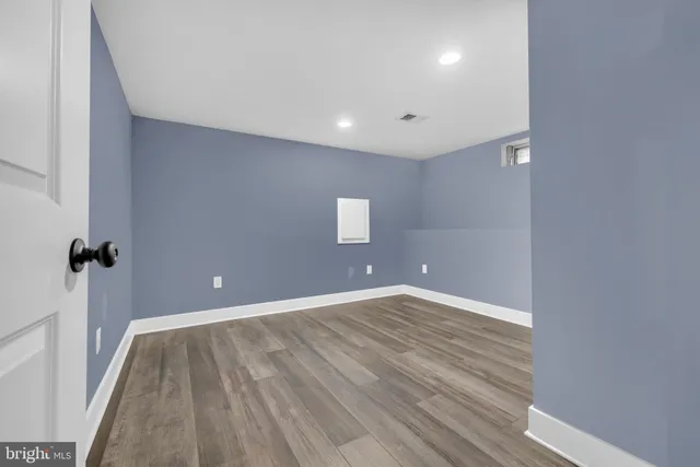 a view of a room with wooden floor