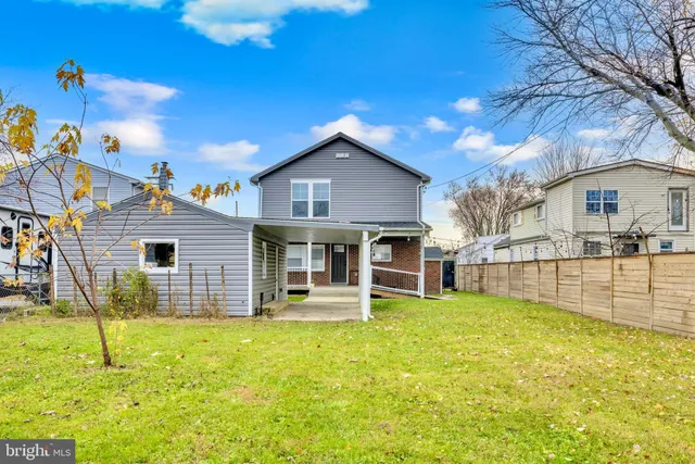 a view of a house with a backyard porch and sitting area