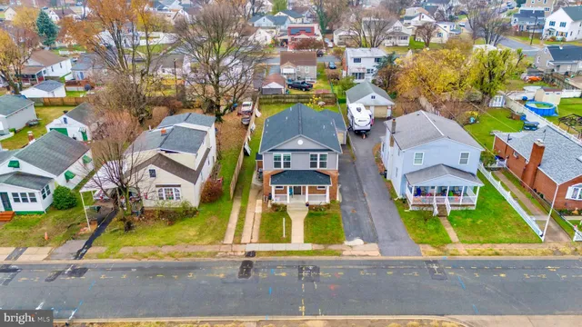 an aerial view of residential houses with yard