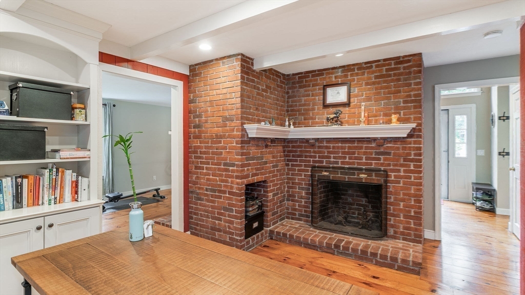 142 Baker Street Walpole, MA 02081 - Photo 18 of 42 a living room with furniture flat screen tv and a fireplace