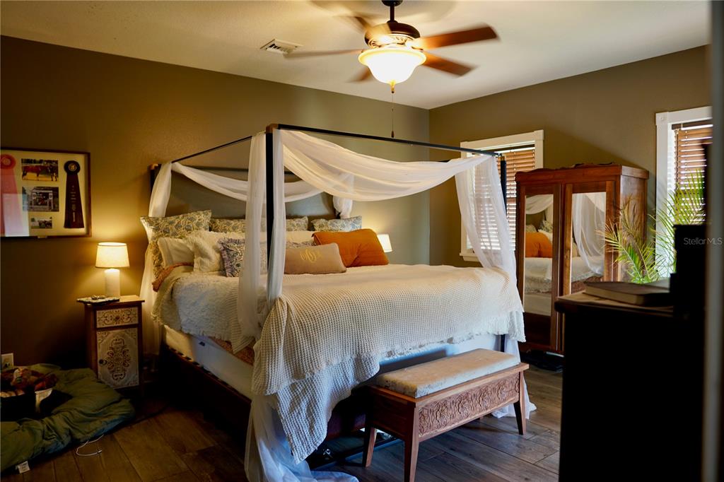 12895 Northwest Gainesville Road Reddick, FL 32686 - Photo 13 of 51 a bedroom with a bed and wooden floor