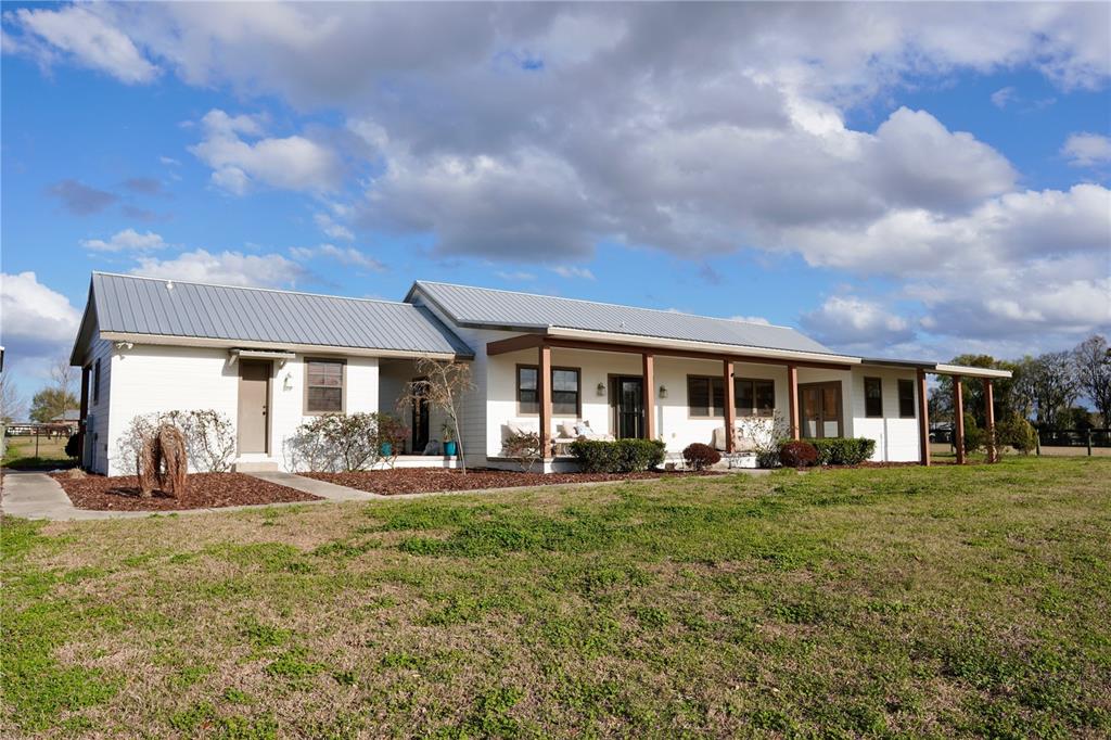 12895 Northwest Gainesville Road Reddick, FL 32686 - Photo 2 of 51 a front view of a house with a yard