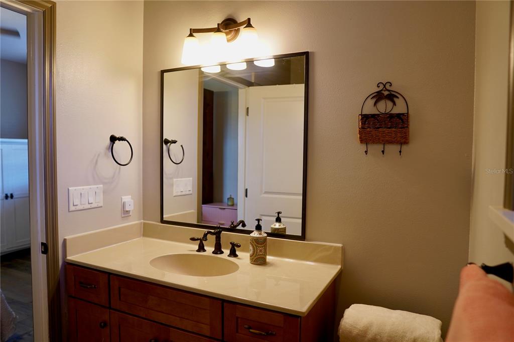 12895 Northwest Gainesville Road Reddick, FL 32686 - Photo 22 of 51 a bathroom with a sink and a mirror