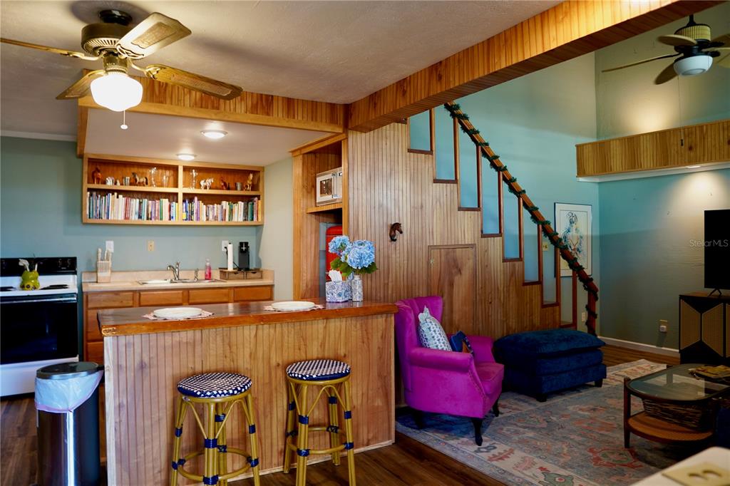 12895 Northwest Gainesville Road Reddick, FL 32686 - Photo 42 of 51 a view of a livingroom with furniture a flat screen tv and a chandelier