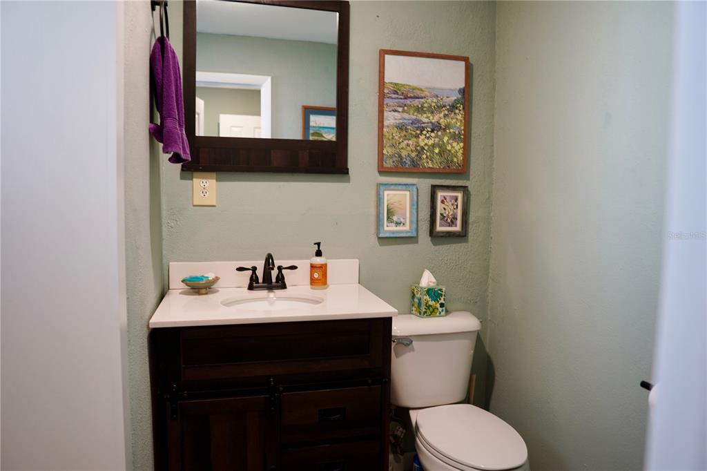 12895 Northwest Gainesville Road Reddick, FL 32686 - Photo 49 of 51 a bathroom with a sink mirror and a toilet