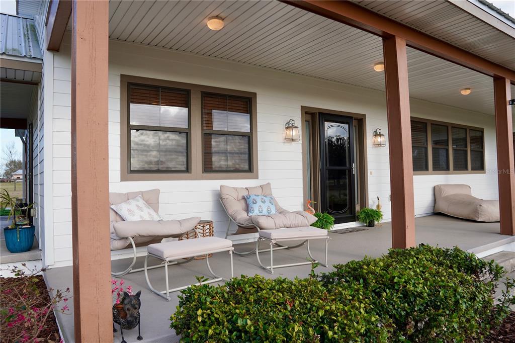 12895 Northwest Gainesville Road Reddick, FL 32686 - Photo 5 of 51 a view of a patio with table and chairs and potted plants