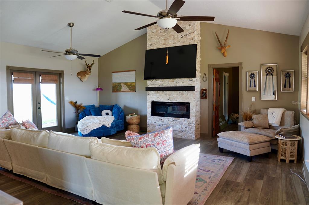 12895 Northwest Gainesville Road Reddick, FL 32686 - Photo 6 of 51 a living room with furniture fireplace and flat screen tv