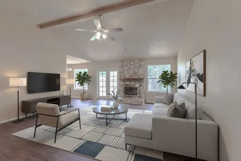 a living room with furniture a fireplace and a flat screen tv