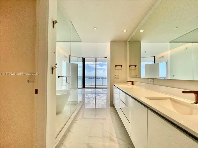 a view of a hallway with workspace and a window