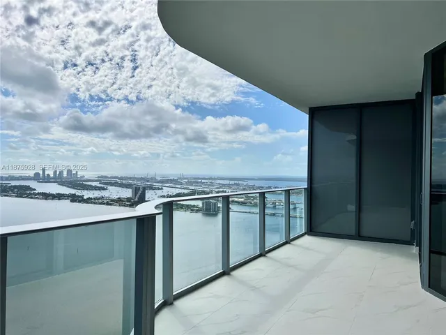 a spacious bathroom with a granite countertop sink and washing machine