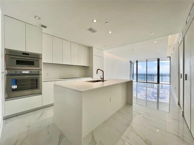 a bathroom with a granite countertop sink mirror and a bathtub